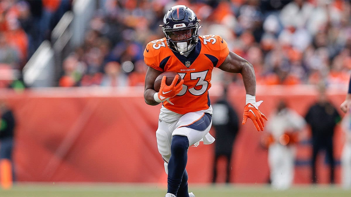 Denver Broncos running back Javonte Williams (33) runs the ball in the first quarter against the Los Angeles Chargers at Empower Field at Mile High