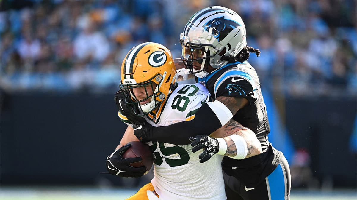 Green Bay Packers tight end Tucker Kraft (85) is tackled by Carolina Panthers cornerback Jaycee Horn