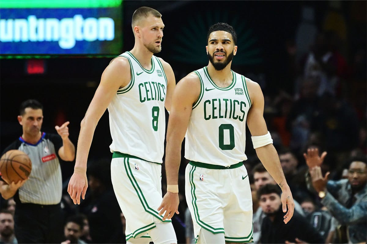 Boston Celtics center Kristaps Porzingis (8) and forward Jayson Tatum (0) react after a play during the second half against the Cleveland Cavaliers at Rocket Mortgage FieldHouse.