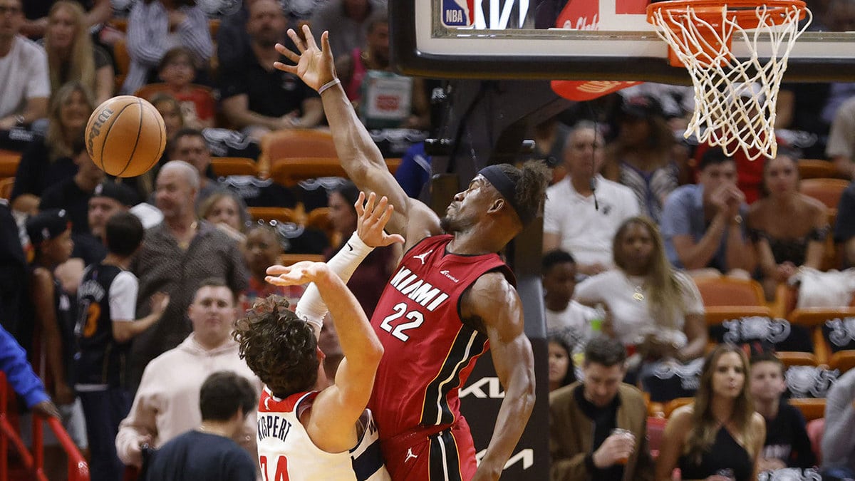 Miami Heat forward Jimmy Butler (22) blocks a shot by Washington Wizards forward Corey Kispert (24) in the first half at Kaseya Center.