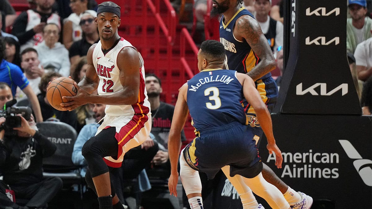 Miami Heat forward Jimmy Butler (22) looks to pass as New Orleans Pelicans guard CJ McCollum (3) defends during the first half at Kaseya Center.
