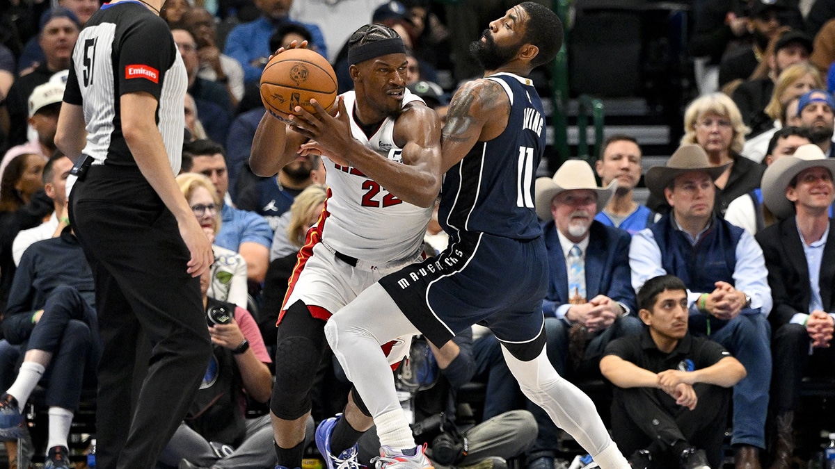 Miami Heat forward Jimmy Butler (22) looks to move the ball past Dallas Mavericks guard Kyrie Irving (11) during the second half at the American Airlines Center. 
