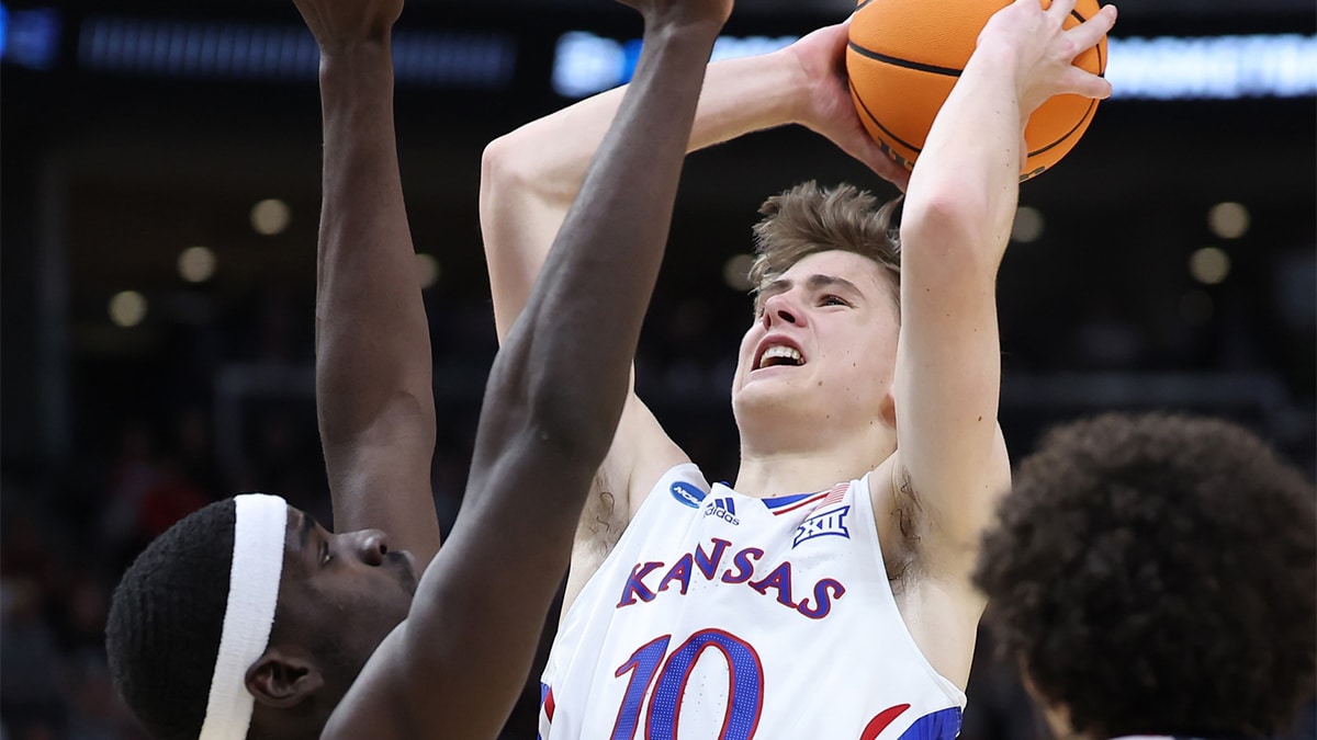 Kansas Jayhawks guard Johnny Furphy (10) shoots against Gonzaga Bulldogs forward Graham Ike (13) during the second half in the second round of the 2024 NCAA Tournament at Vivint Smart Home Arena-Delta Center. 