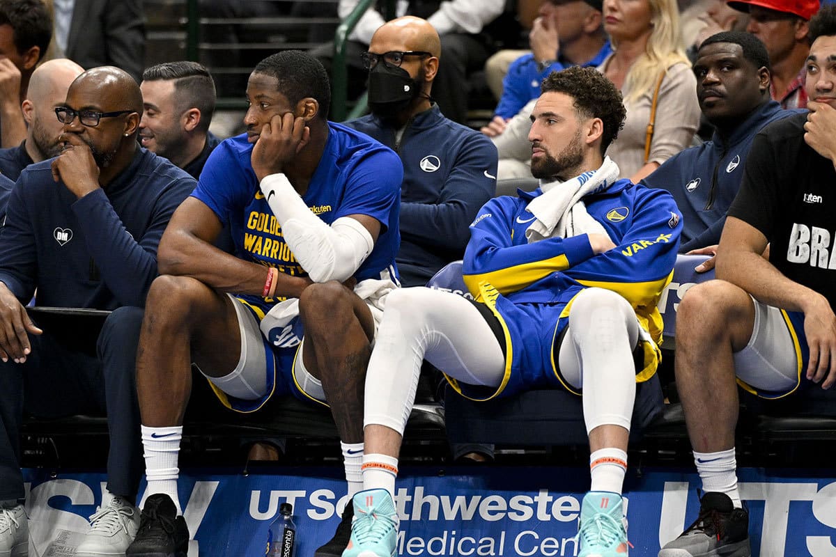 Golden State Warriors guard Klay Thompson (11) (right) sits on the team bench during the second half between the Dallas Mavericks and the Warriors at the American Airlines Center. 