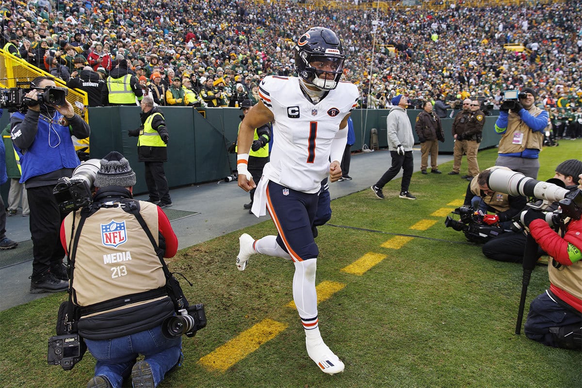 Chicago Bears quarterback Justin Fields (1) runs onto the field prior to the game against the Green Bay Packers at Lambeau Field