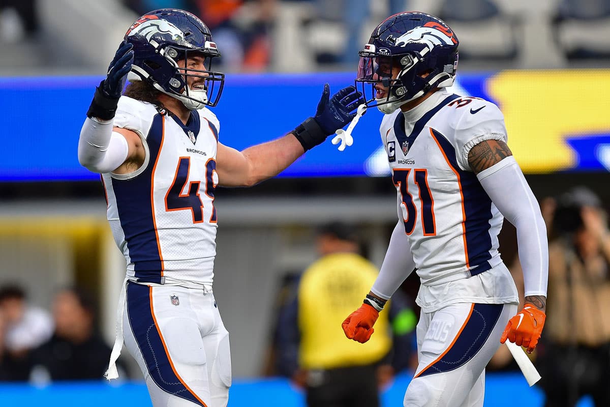 Denver Broncos linebacker Alex Singleton (49) celebrates with safety Justin Simmons (31) after bringing down Los Angeles Chargers quarterback Justin Herbert (10) during the first half at SoFi Stadium. 