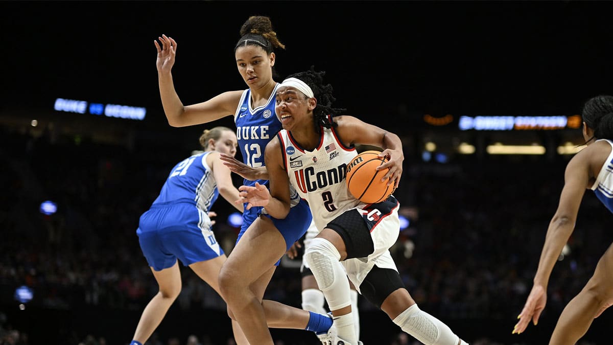 UConn Huskies guard KK Arnold (2) drives to the basket during the first half against Duke Blue Devils forward Delaney Thomas (12) in the semifinals of the Portland Regional of the 2024 NCAA Tournament at the Moda Center.