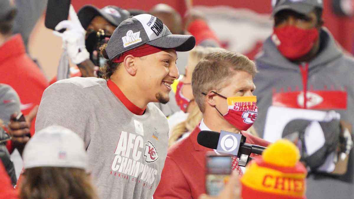 Kansas City Chiefs quarterback Patrick Mahomes (15) and team owner Clark Hunt are interviewed after defeating the Buffalo Bills in the AFC Championship Game at Arrowhead Stadium