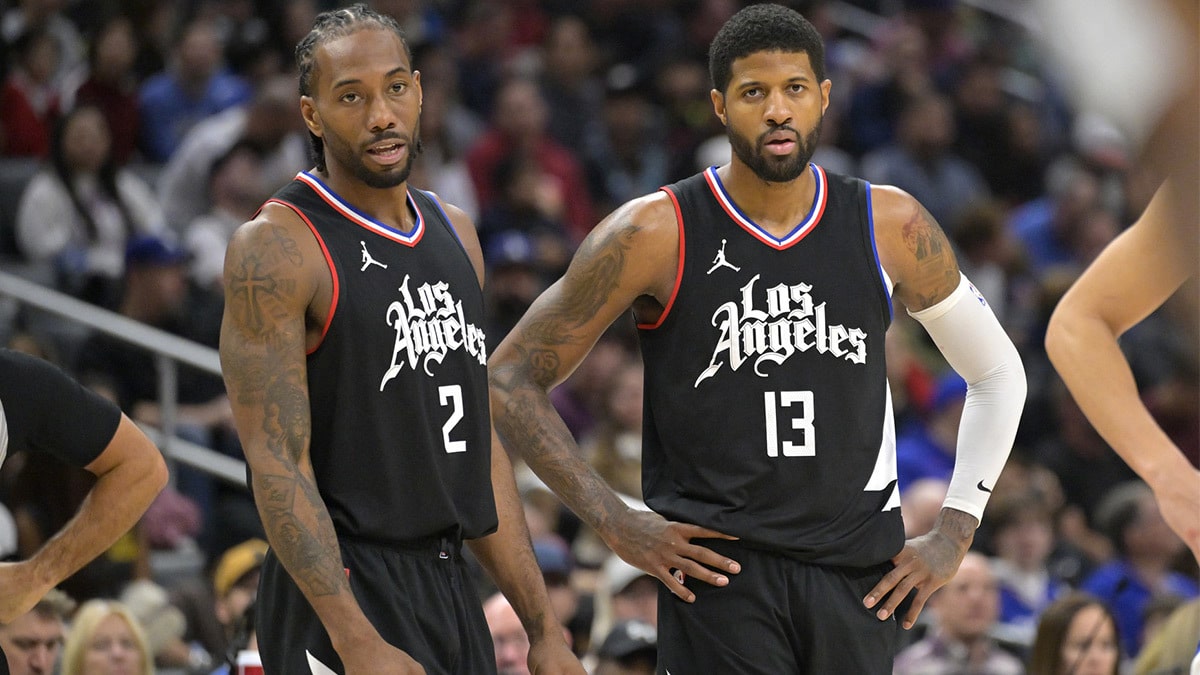 Kawhi Leonard stands next to Paul George in black Clippers jerseys
