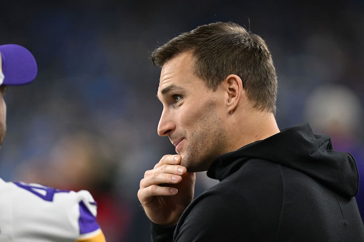 Minnesota Vikings quarterback Kirk Cousins (8) talks with teammates prior to their game against the Detroit Lions at Ford Field.