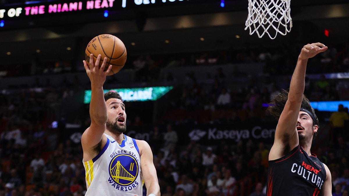 Golden State Warriors guard Klay Thompson (11) drives to the basket against Miami Heat guard Jaime Jaquez Jr. (11) during the first quarter at Kaseya Center.