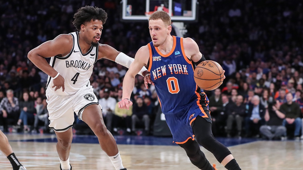 New York Knicks guard Donte DiVincenzo (0) looks to drive past Brooklyn Nets guard Dennis Smith Jr. (4) in the fourth quarter at Madison Square Garden.
