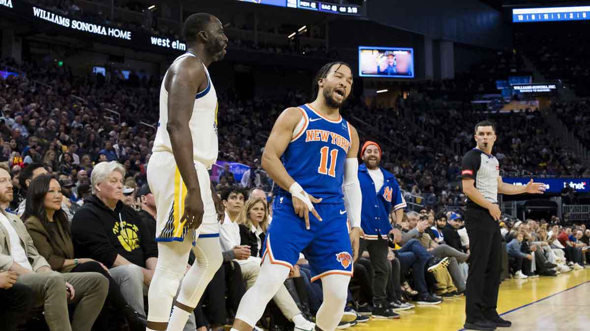 New York Knicks guard Jalen Brunson (11) reacts in front of Golden State Warriors center Draymond Green (23) during the first half at Chase Center