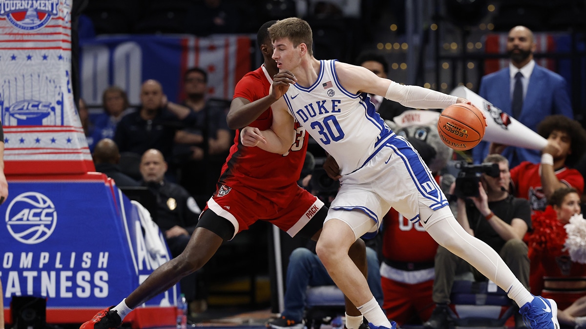 Duke Blue Devils center Kyle Filipowski (30) drives to the basket as North Carolina State forward Mohamed Diarra (23) defends in the first half at Capital One Arena, Armando Bacot  watches on TV