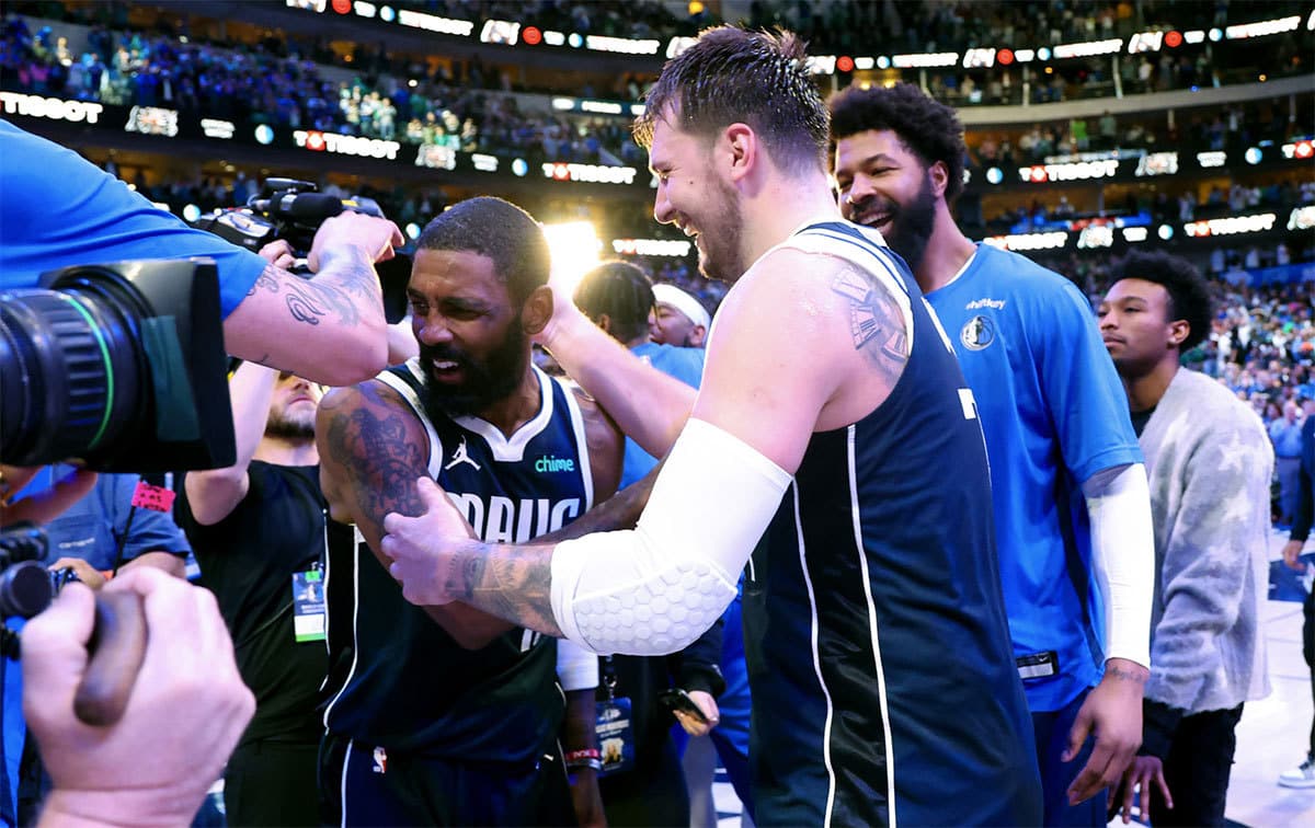 Dallas Mavericks guard Kyrie Irving (11) celebrates with Dallas Mavericks guard Luka Doncic (77) after the win against the Denver Nuggets at American Airlines Center.