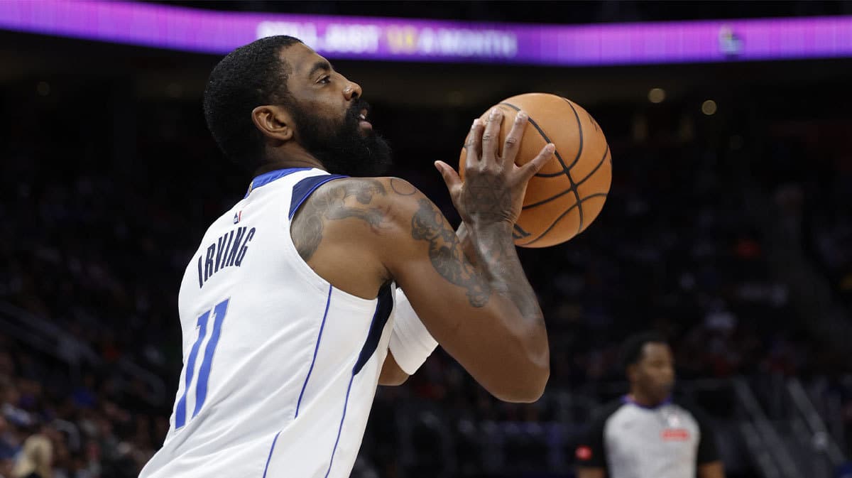 Dallas Mavericks guard Kyrie Irving (11) shoots in the first half against the Detroit Pistons at Little Caesars Arena.