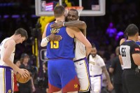 Los Angeles Lakers forward LeBron James (23) is greeted by Denver Nuggets center Nikola Jokic (15) at the start of the game at Crypto.com Arena.