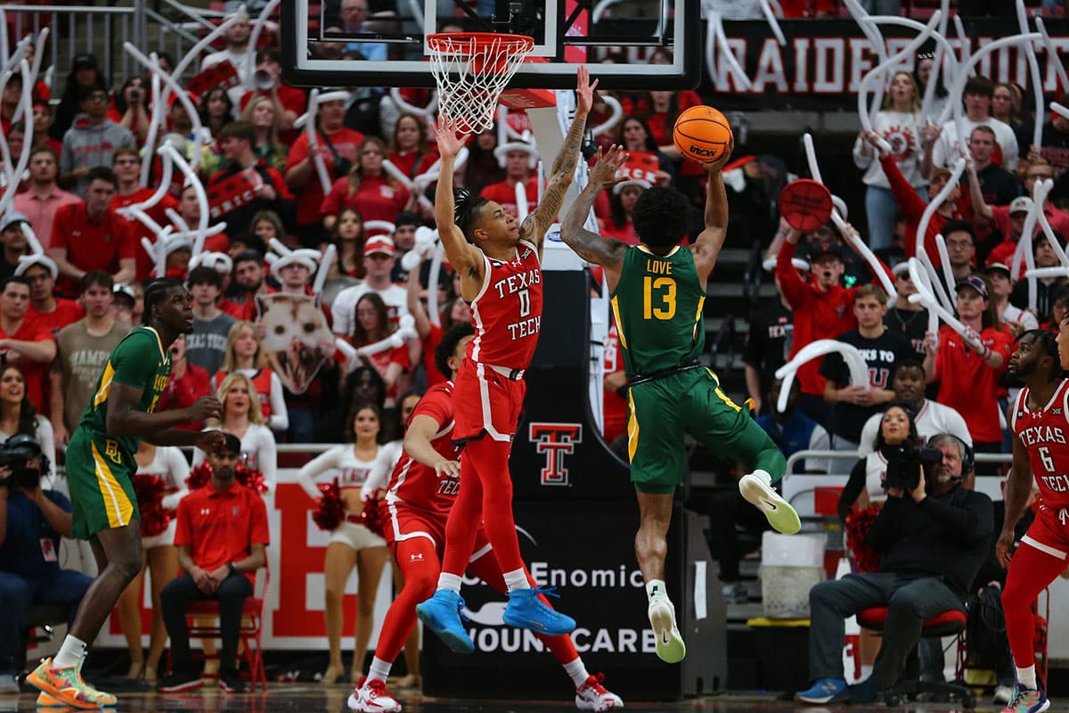 Baylor Bears guard Langston Love (13) shoots over Texas Tech Red Raiders guard Chance McMillian (0) in the second half at United Supermarkets Arena.