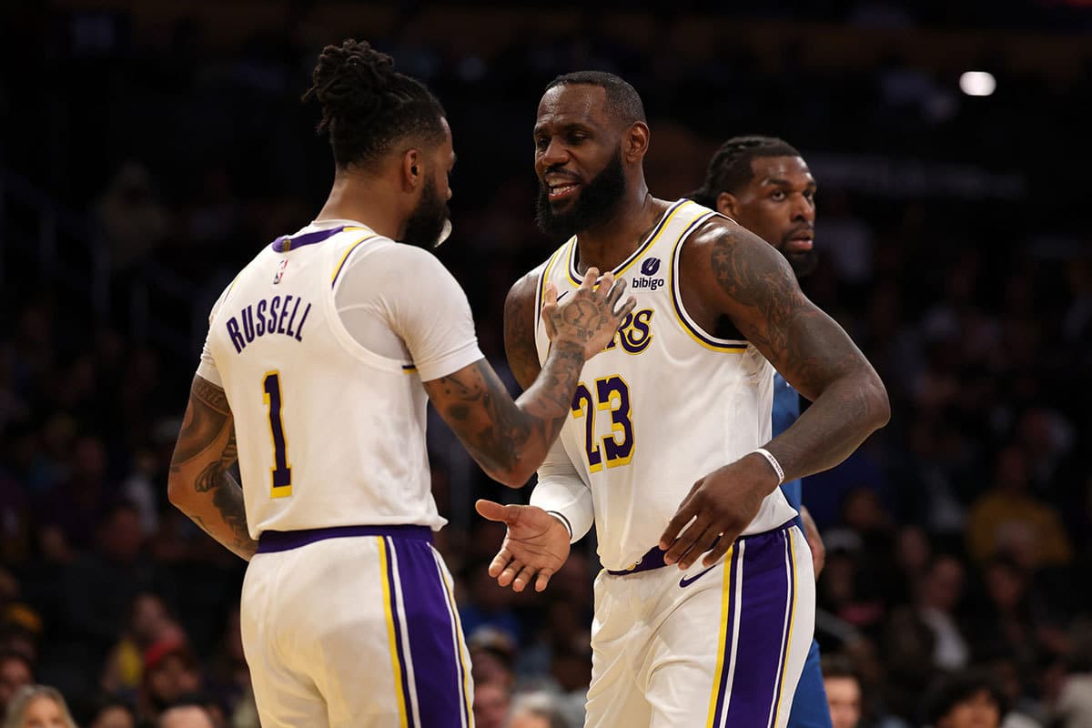Los Angeles Lakers forward LeBron James (23) greets guard D'Angelo Russell (1) after Russell scored a basket during the second quarter against the Minnesota Timberwolves at Crypto.com Arena. 