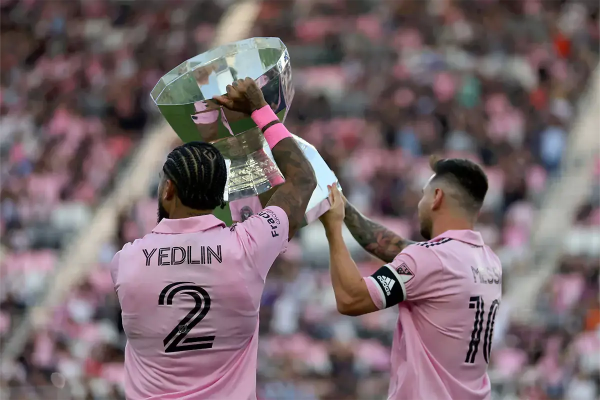 Inter Miami defender DeAndre Yedlin (2) and forward Lionel Messi (10) hoist the Leagues Cup trophy before the game against Nashville SC at DRV PNK Stadium.