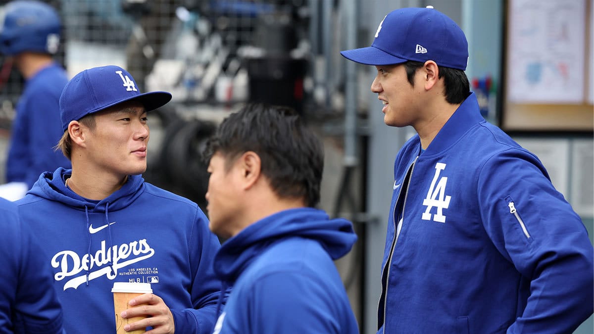 Los Angeles Dodgers designated hitter Shohei Ohtani (R) talks with starting pitcher Yoshinobu Yamamoto (L) during the game against the Los Angeles Angels at Dodger Stadium