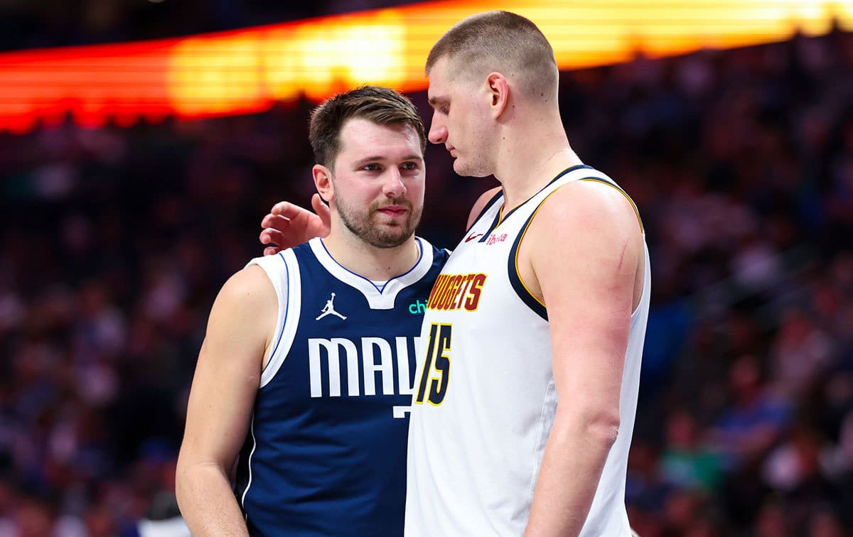 Dallas Mavericks guard Luka Doncic (77) speaks with Denver Nuggets center Nikola Jokic (15) during the second half at American Airlines Center. 