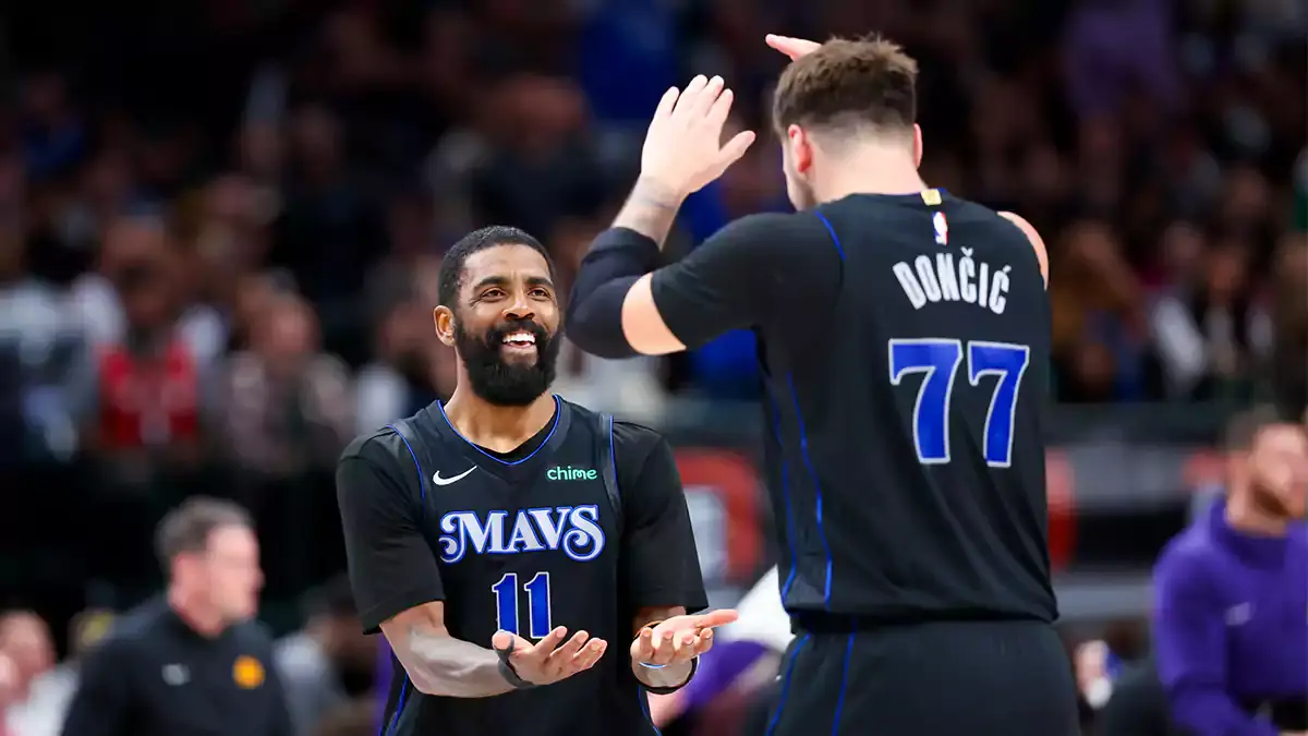 Dallas Mavericks guard Kyrie Irving (11) celebrates with Dallas Mavericks guard Luka Doncic (77) during the second half against the Phoenix Suns at American Airlines Center.