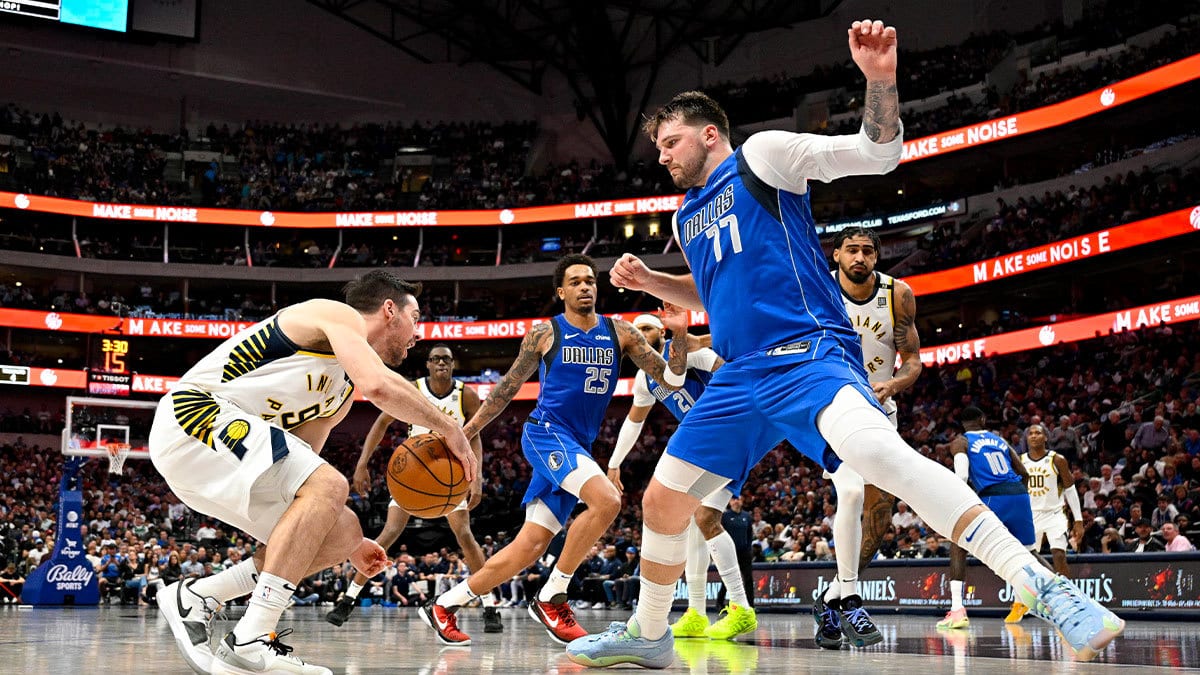 Indiana Pacers guard T.J. McConnell (9) looks to move the ball past Dallas Mavericks guard Luka Doncic (77) during the second half at the American Airlines Center. 
