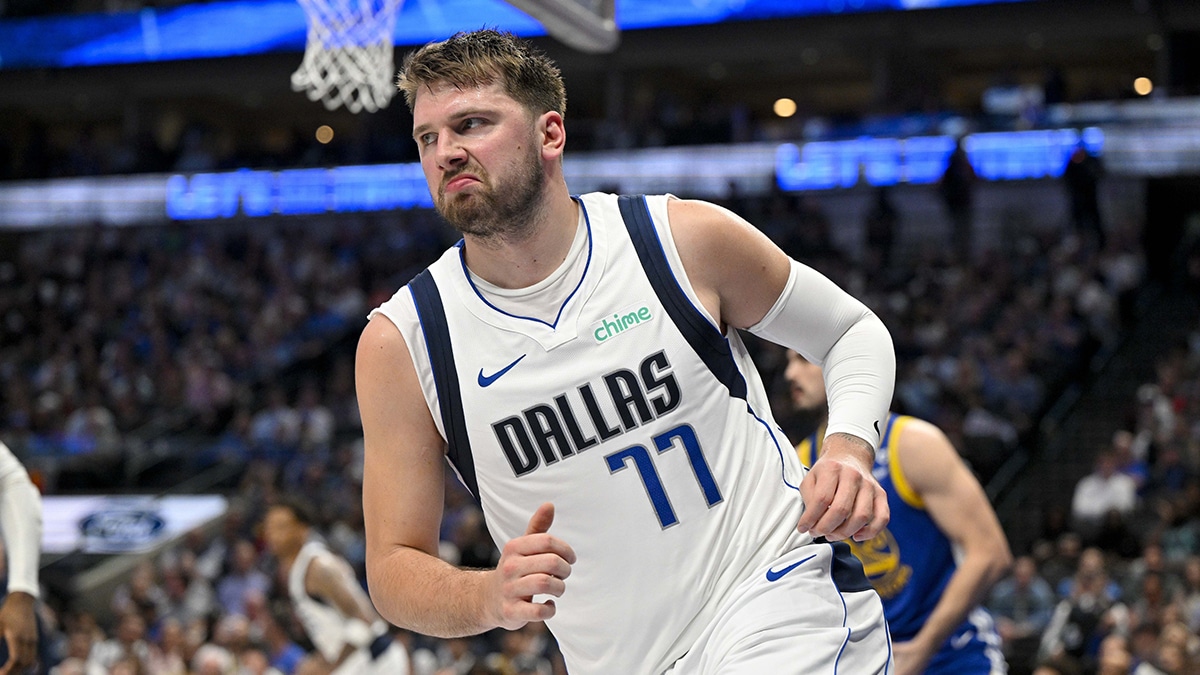 Dallas Mavericks guard Luka Doncic (77) reacts to making a basket against the Golden State Warriors during the first half at the American Airlines