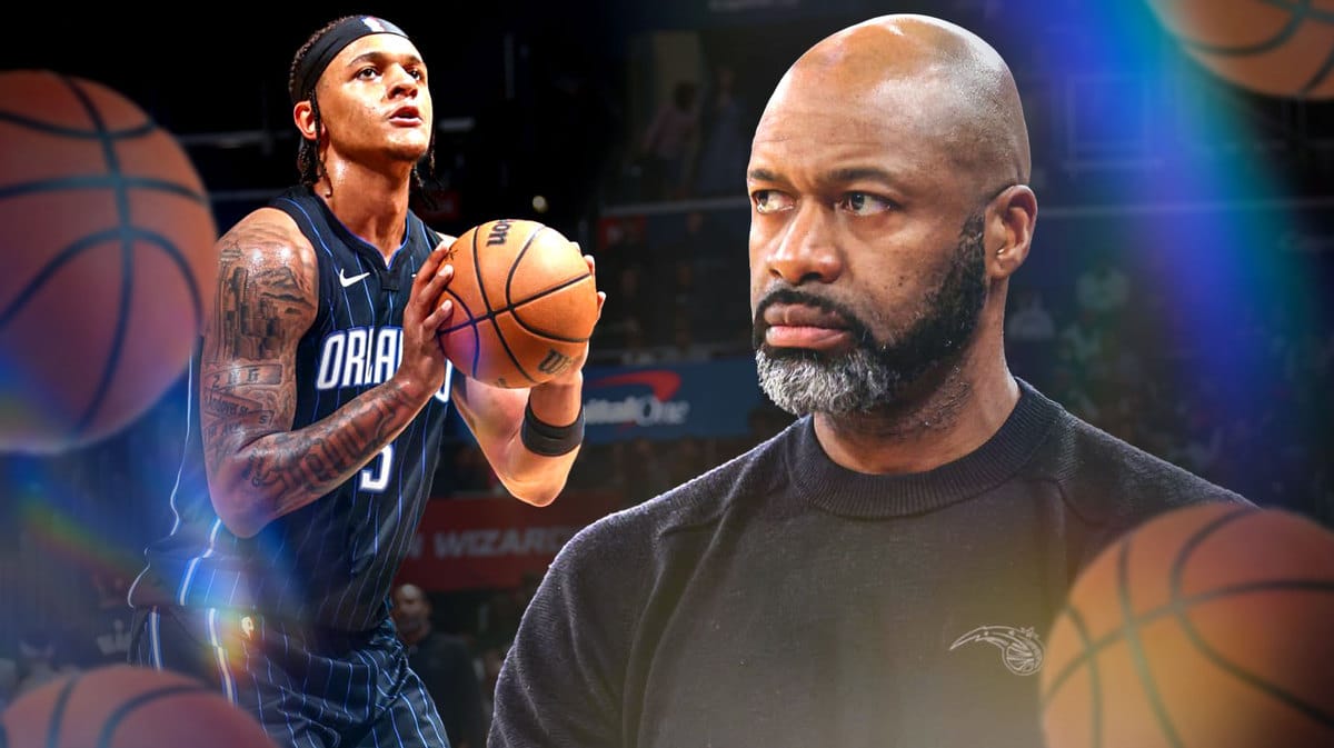 Jamhal Mosley looking serious with Paolo Banchero shooting the ball in Scotiabank Arena, Toronto.
