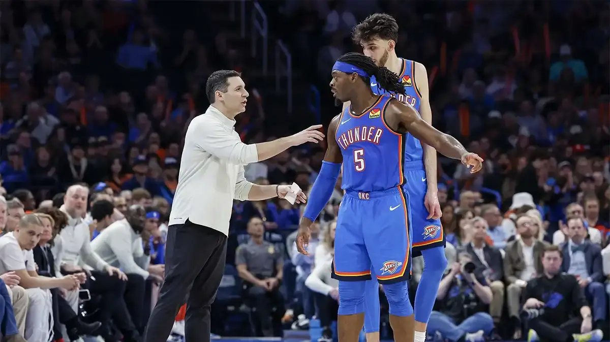 Oklahoma City Thunder head coach Mark Daigneault talks to Oklahoma City Thunder guard Luguentz Dort (5) and orward Chet Holmgren (7) during a time out against the Denver Nuggets in the second half at Paycom Center.