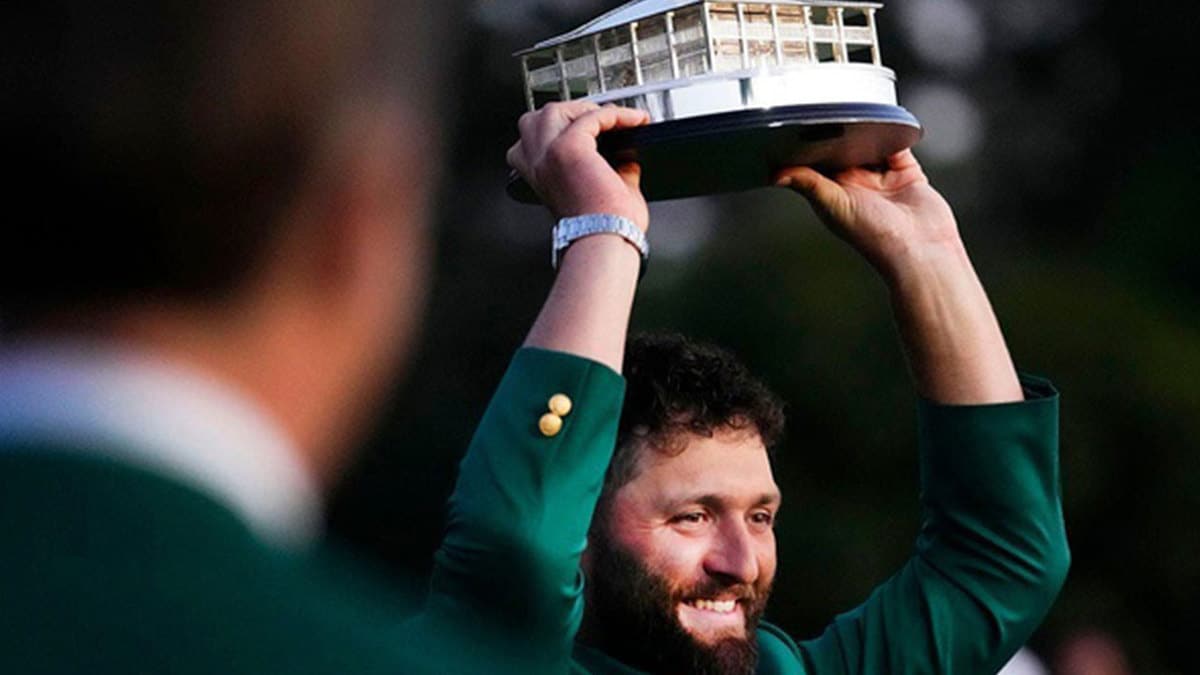 Masters champion Jon Rahm holds up the trophy after the final round of The Masters golf tournament