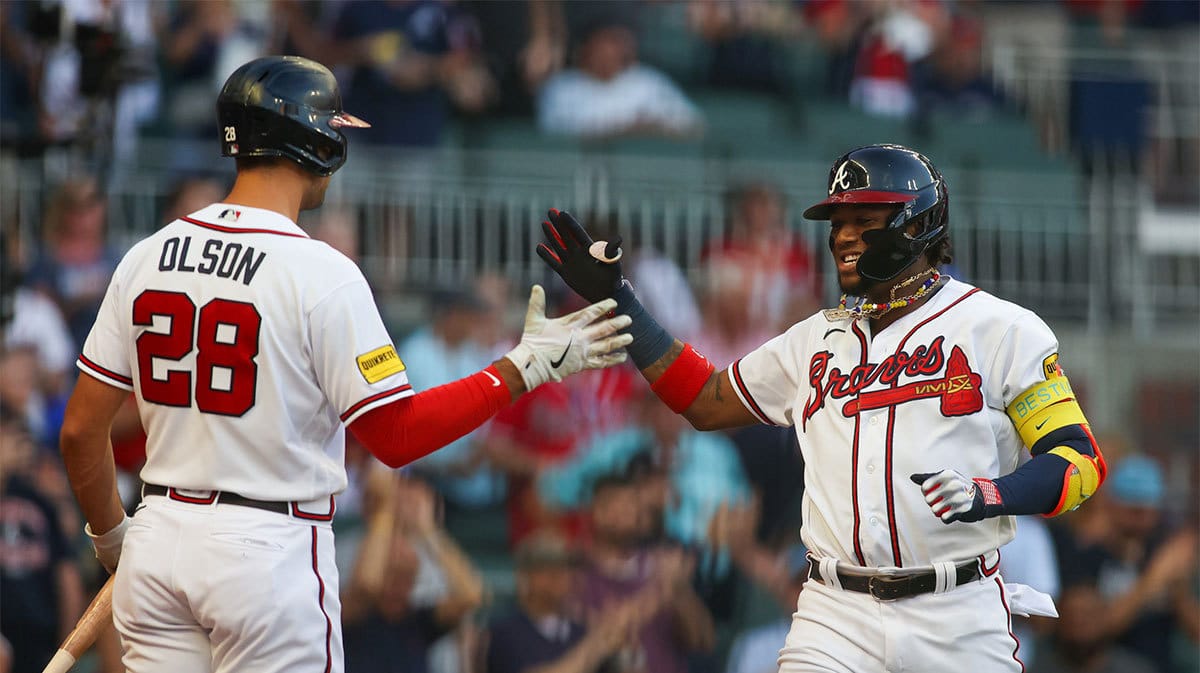 Atlanta Braves right fielder Ronald Acuna Jr. (13) celebrates after a home run with first baseman Matt Olson (28) against the St. Louis Cardinals in the first inning at Truist Park.