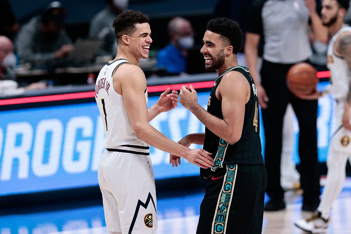 Denver Nuggets forward Michael Porter Jr. (1) greets his brother Memphis Grizzlies forward Jontay Porter (4) after the game at Ball Arena. 