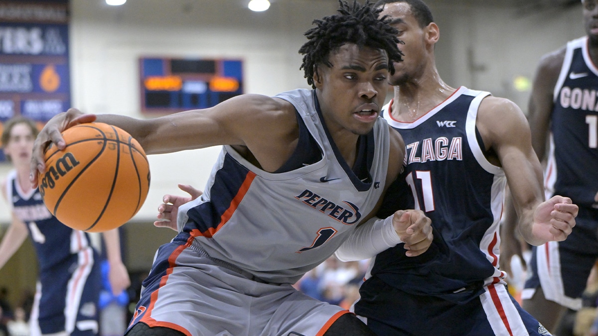 Pepperdine Waves guard Michael Ajayi (1) is defended by Gonzaga Bulldogs guard Nolan Hickman (11) in the second half at Firestone Fieldhouse.