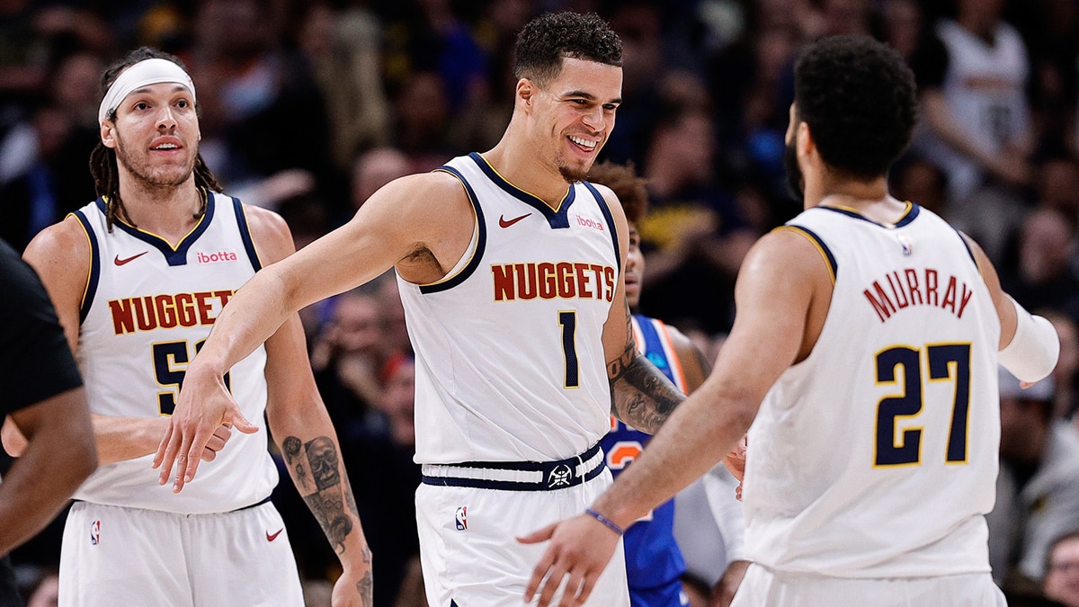 Denver Nuggets forward Michael Porter Jr. (1) reacts with guard Jamal Murray (27) ahead of forward Aaron Gordon (50) in the fourth quarter against the New York Knicks at Ball Arena
