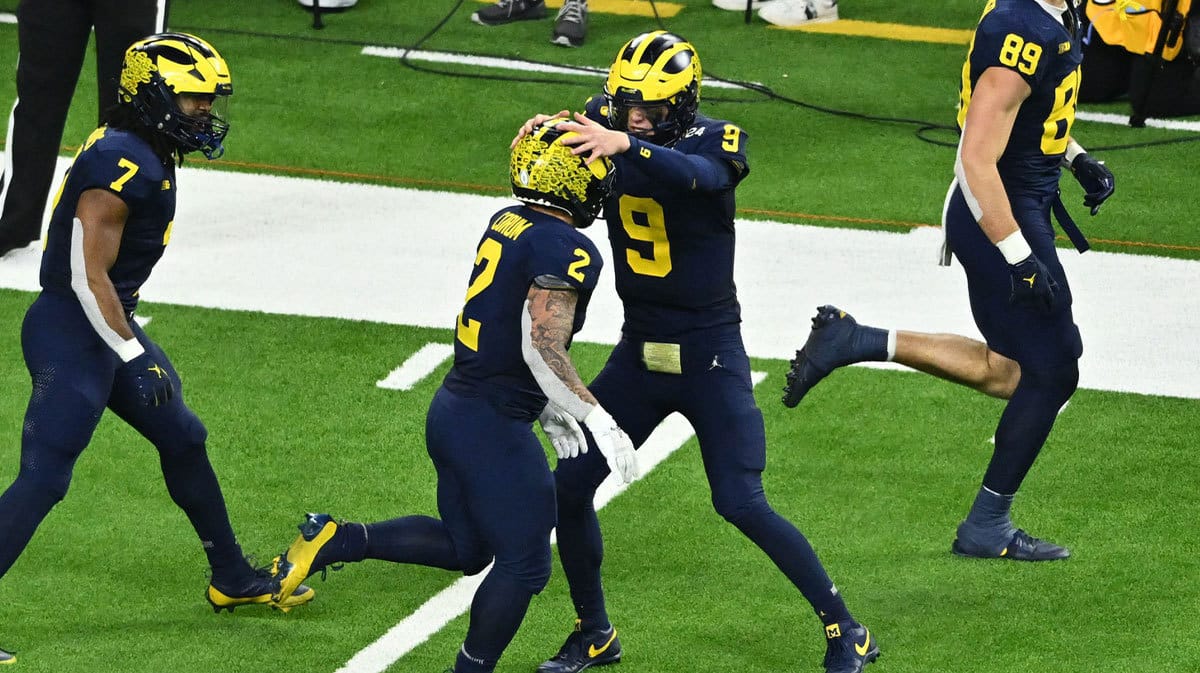 Michigan Wolverines running back Blake Corum (2) is congratulated by Michigan Wolverines quarterback J.J. McCarthy (9) after his touchdown run against the Washington Huskies in the fourth quarter in the 2024 College Football Playoff national championship game at NRG Stadium. 