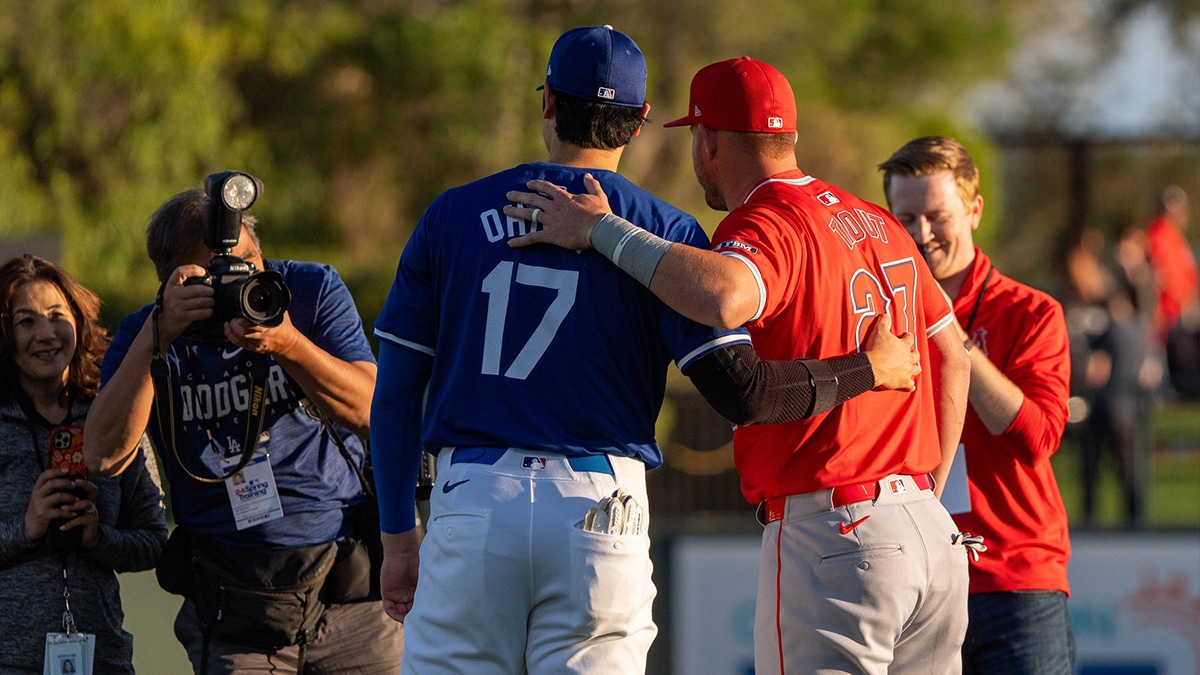 Los Angeles Dodgers two-way player Shohei Ohtani (17) and Los Angeles Angels outfielder Mike Trout (27) pose for a photo before the start of a spring training game at Camelback Ranch-Glendale. 