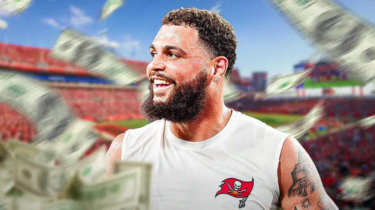 Mike Evans with money all around him. Buccaneers stadium or logo in the background