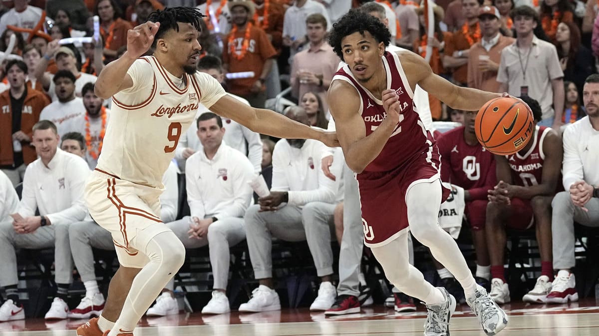 Oklahoma Sooners guard Milos Uzan (12) drives to the basket while defended by Texas Longhorns guard Ithiel Horton (9) during the second half at Moody Center.