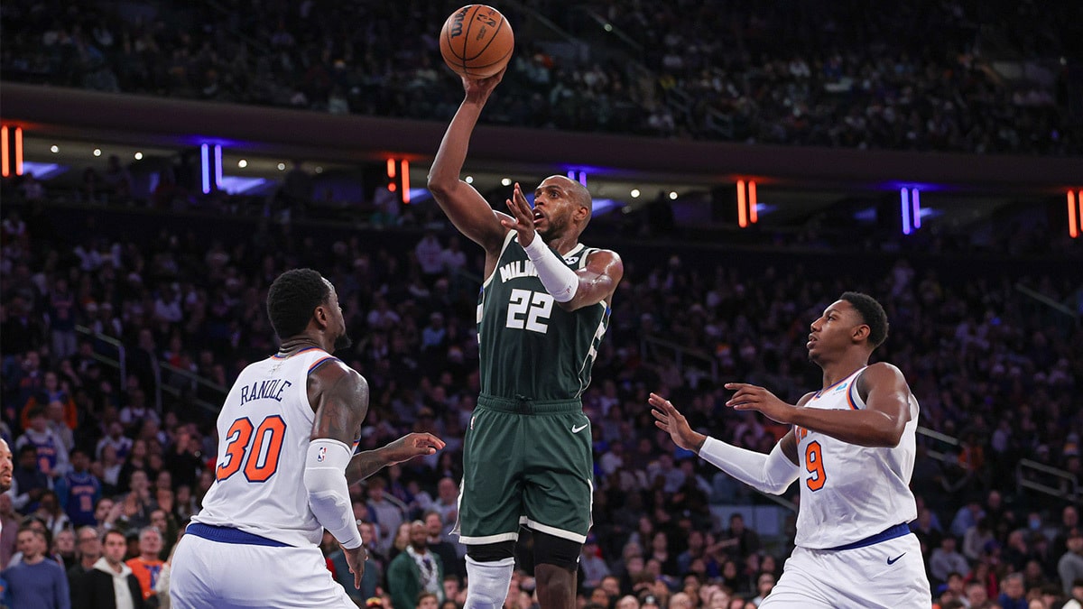 Milwaukee Bucks forward Khris Middleton (22) shoots the ball in front of New York Knicks forward Julius Randle (30) and guard RJ Barrett (9) during the second half at Madison Square Garden. 