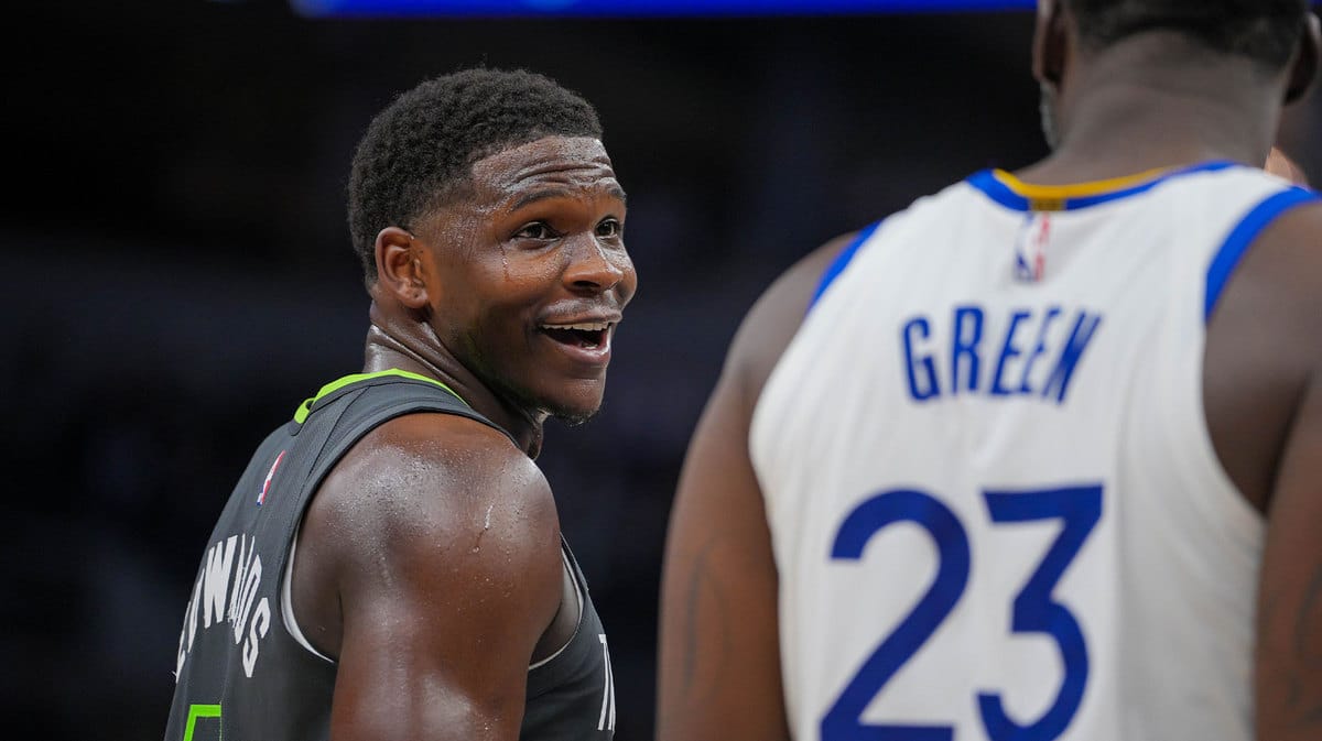 Minnesota Timberwolves guard Anthony Edwards (5) talks to Golden State Warriors forward Draymond Green (23) during a free throw in the third quarter at Target Center