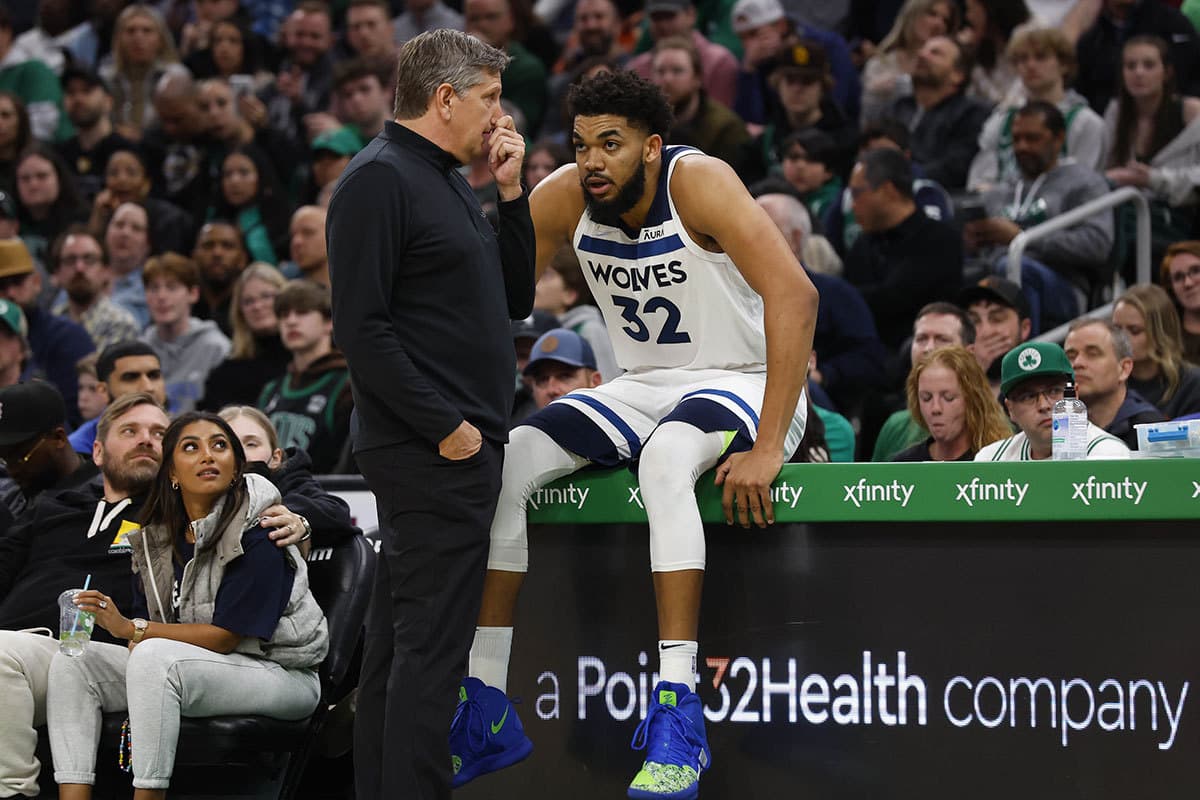 Minnesota Timberwolves head coach Chris Finch talks with center Karl-Anthony Towns (32) during the second half against the Boston Celtics