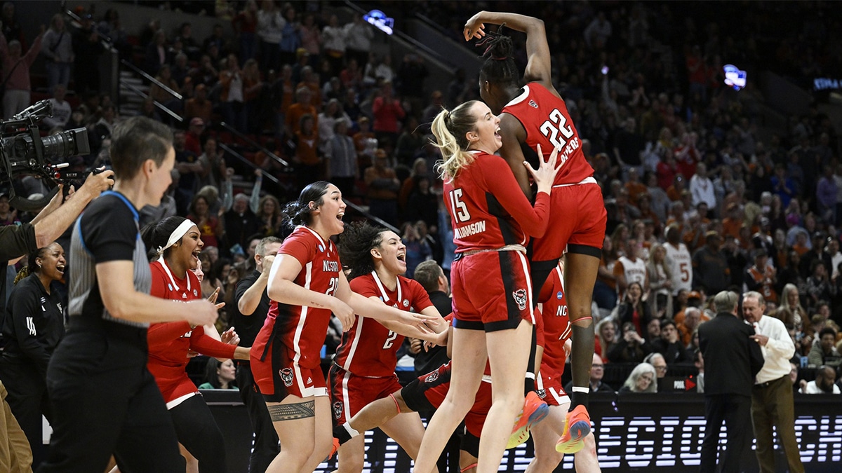 NC State Wolfpack center Lizzy Williamson (15) and guard Saniya Rivers (22) celebrate with teammates after defeating the Texas Longhorns in the finals of the Portland Regional of the NCAA Tournament at the Moda Center center.