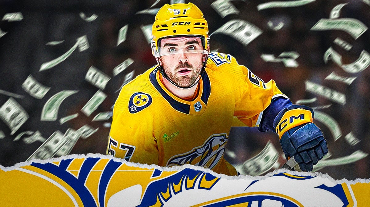 Predators' defenseman Dante Fabbro with money around him.