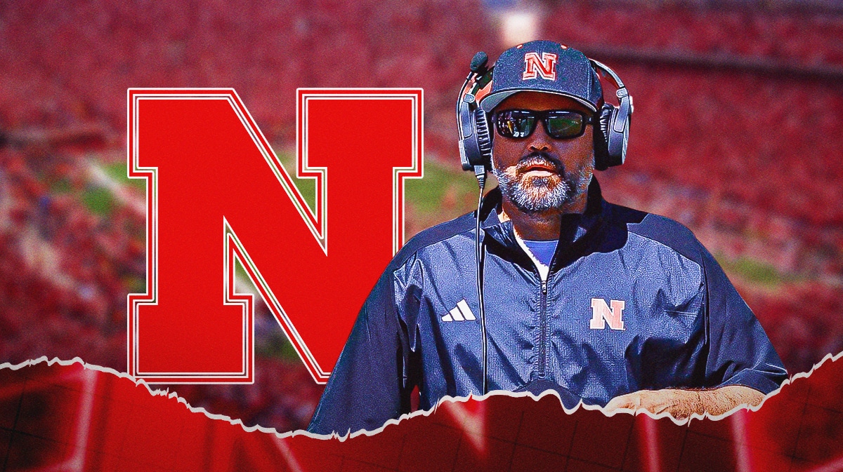 Nebraska football coach Matt Rhule stands next Big 10 logo,