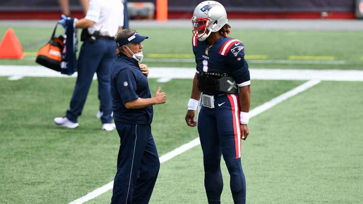 ; New England Patriots head coach Bill Belichick talks with quarterback Cam Newton (1) before a game against the Miami Dolphins at Gillette Stadium