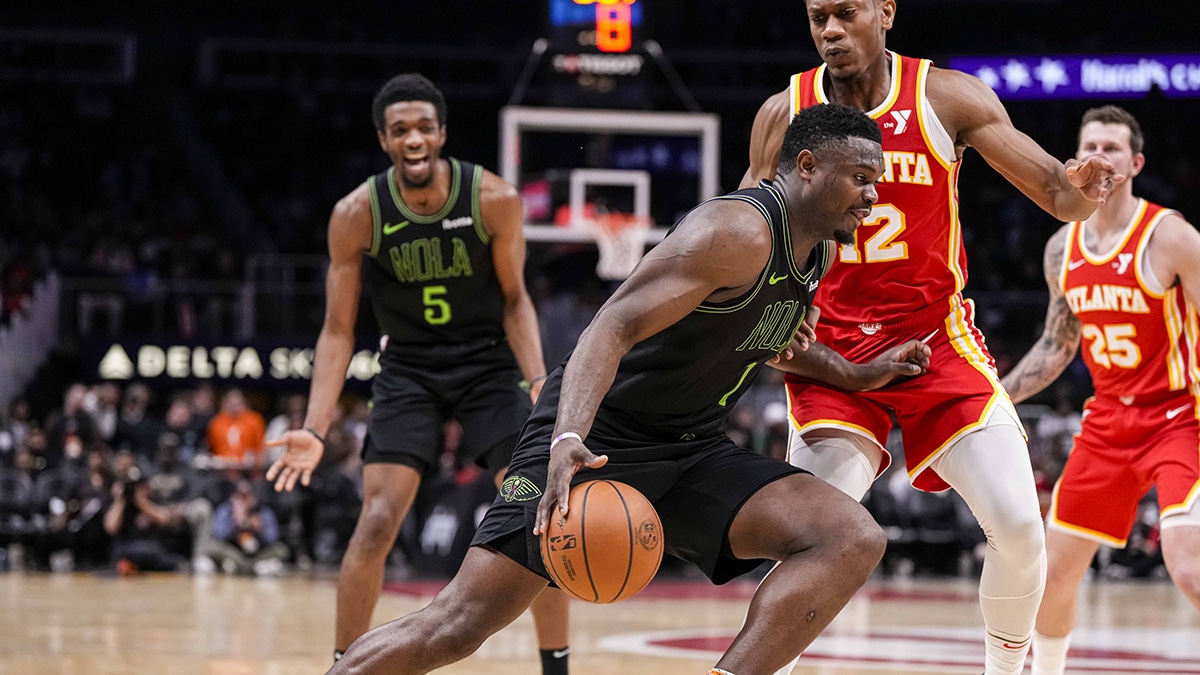 New Orleans Pelicans forward Zion Williamson (1) dribbles against Atlanta Hawks forward De'Andre Hunter (12) during the second half at State Farm Arena