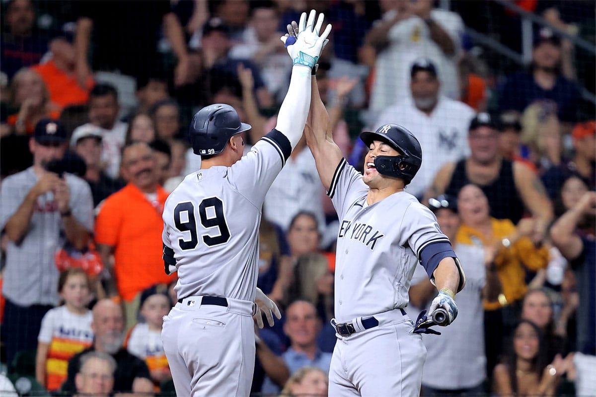 New York Yankees right fielder Aaron Judge (99) is congratulated by New York Yankees designated hitter Giancarlo Stanton (27) after hitting a home run to center field against the Houston Astros during the fifth inning at Minute Maid Park