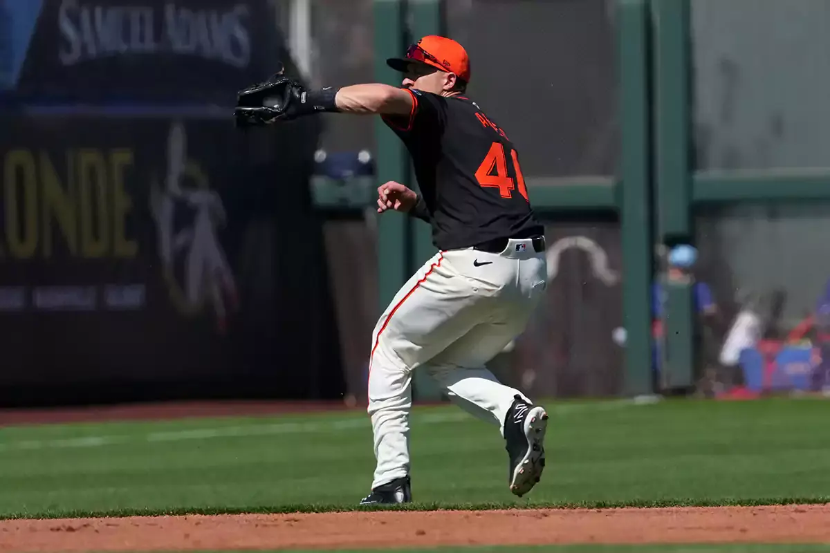 San Francisco Giants shortstop Nick Ahmed (40) fields a ball against the Texas Rangers during the second inning at Scottsdale Stadium.